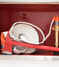 Rescue firefighter equipment, extinguisher, ax and fire line in red box.Fire fighting concept. (C) Shutterstock, Komsan Loonprom